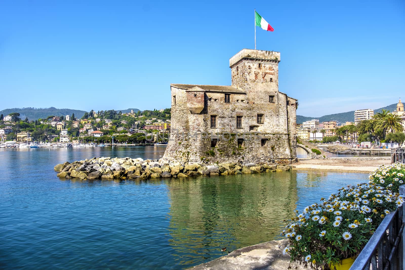 italian castles on sea italian flag - Rapallo Genoa Tigullio gulf near Portofino Italy .