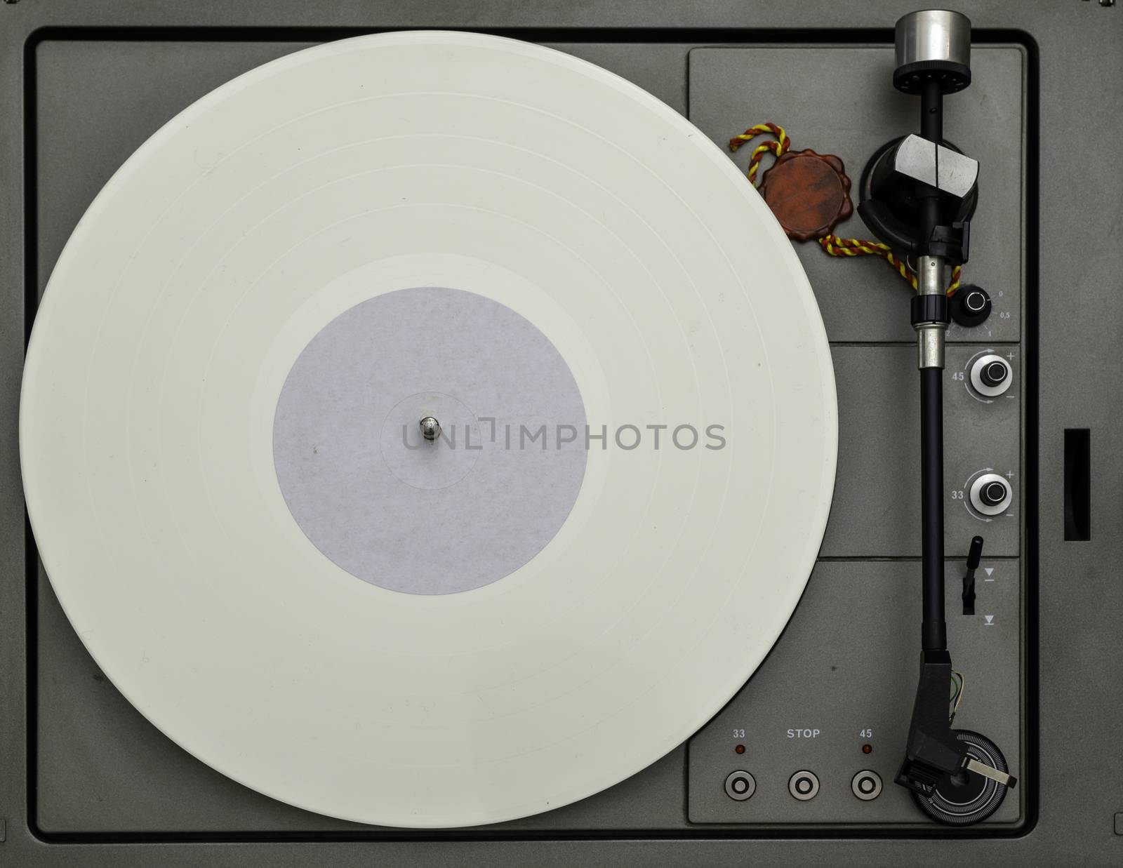 Vintage vinyl turntable with vinyl plate. Listen to music. Top view.