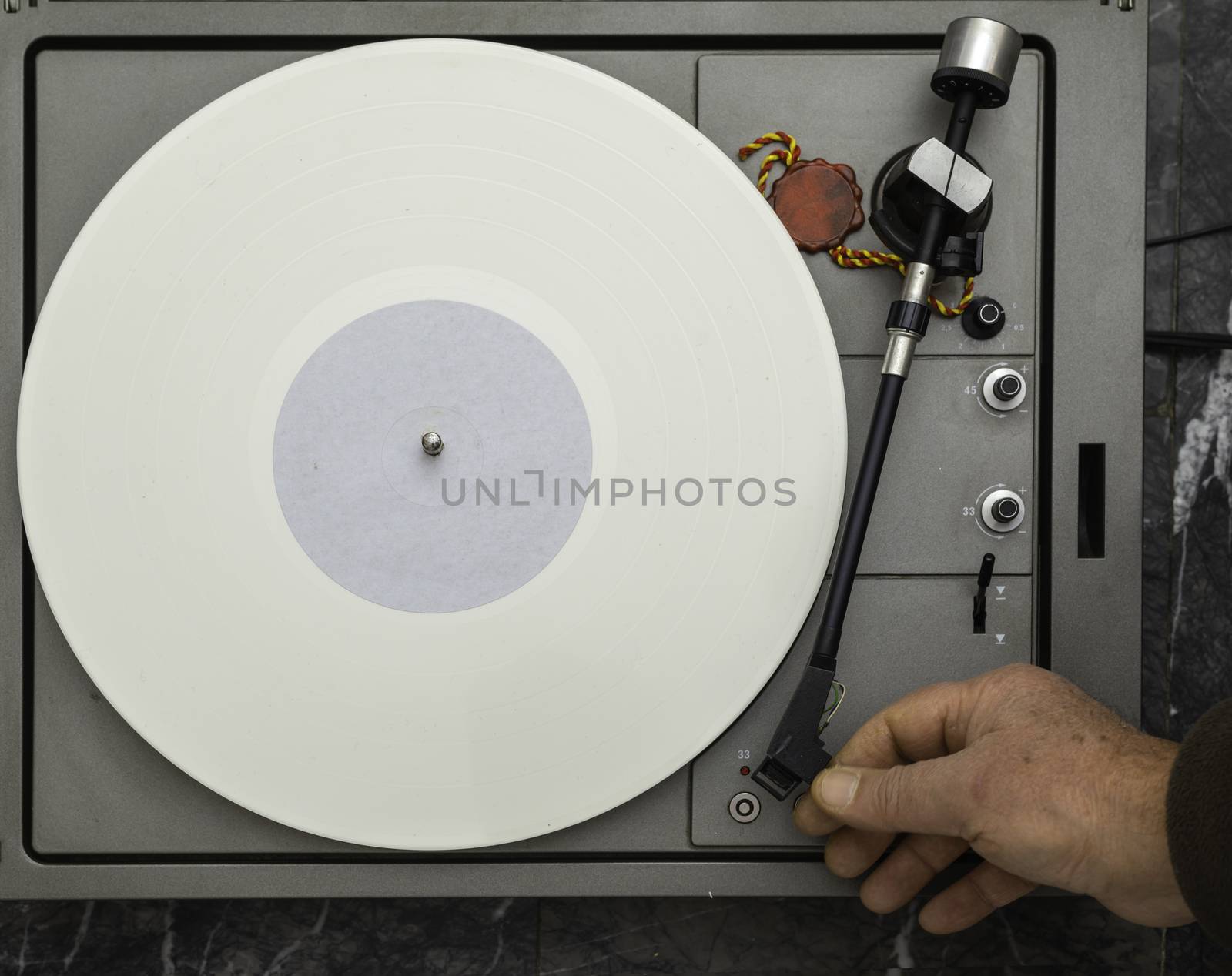 Vintage vinyl turntable with vinyl plate. Listen to music. Top view.