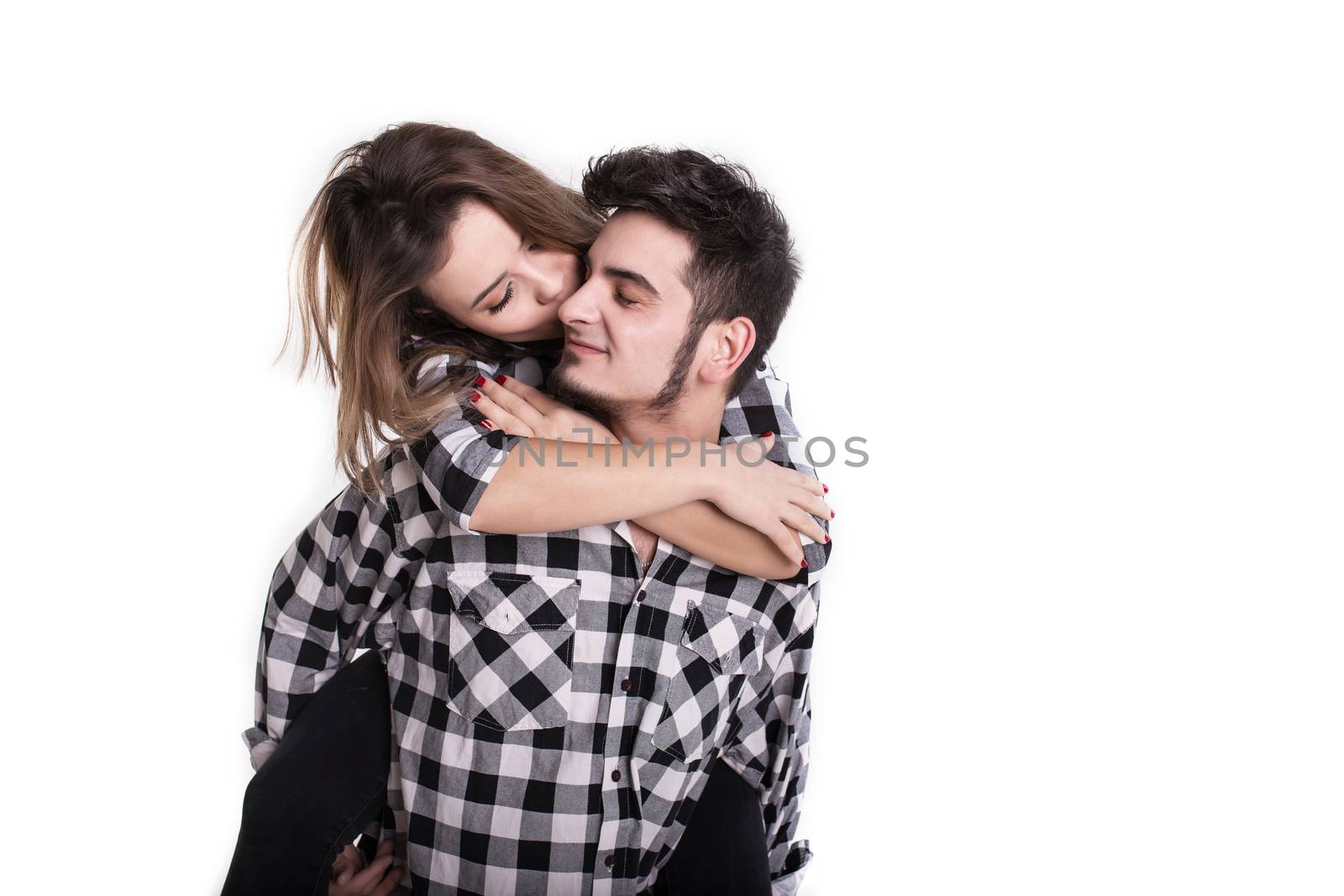 Happy young couple embracing each other and kissing isolated on white background