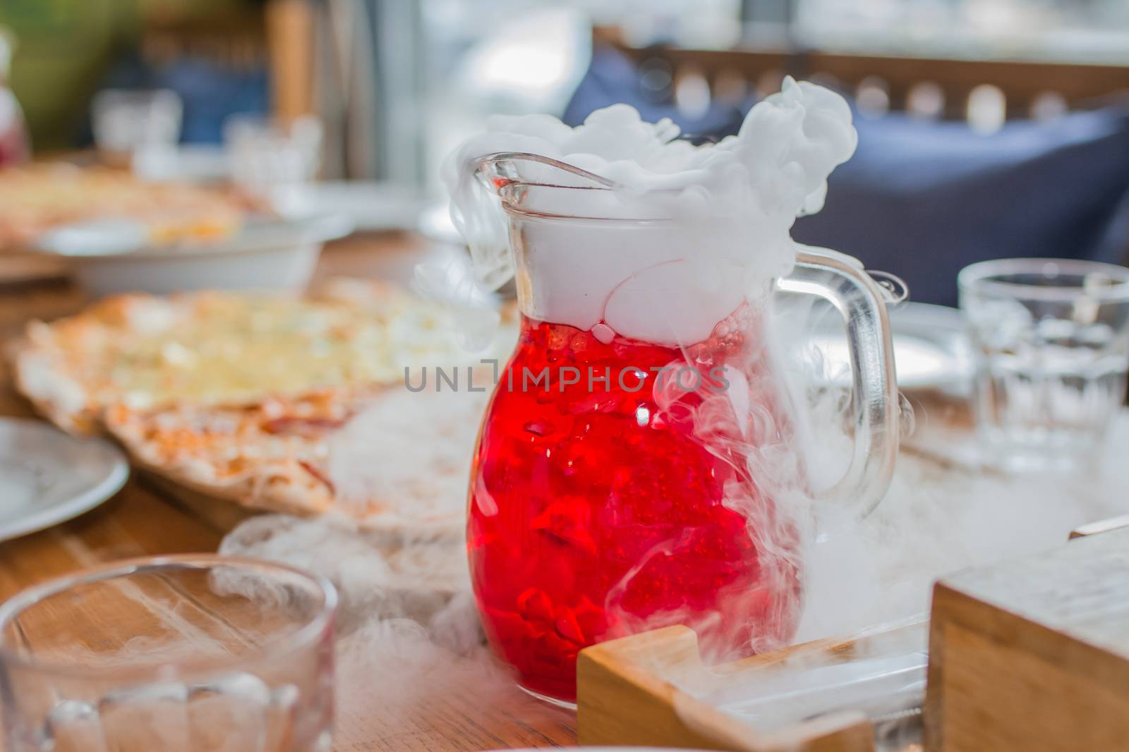 Cold juice with steam and smoke on birthday party table by Angel_a