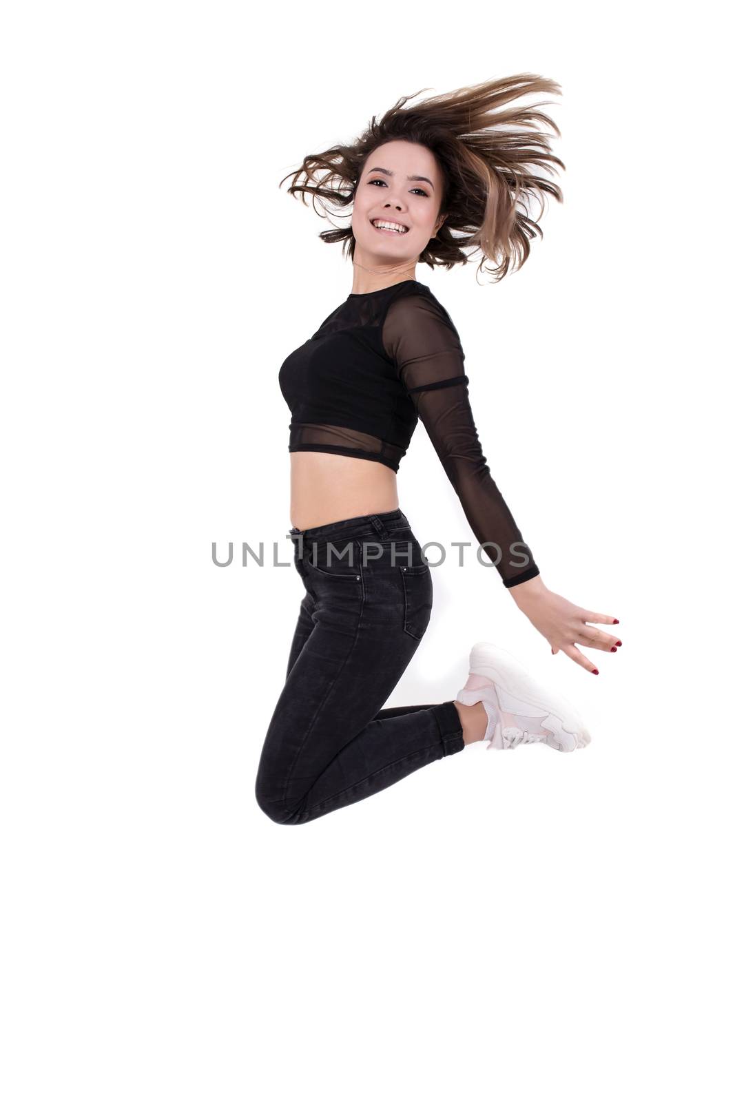 Young girl dancer jumping up on white isolated
