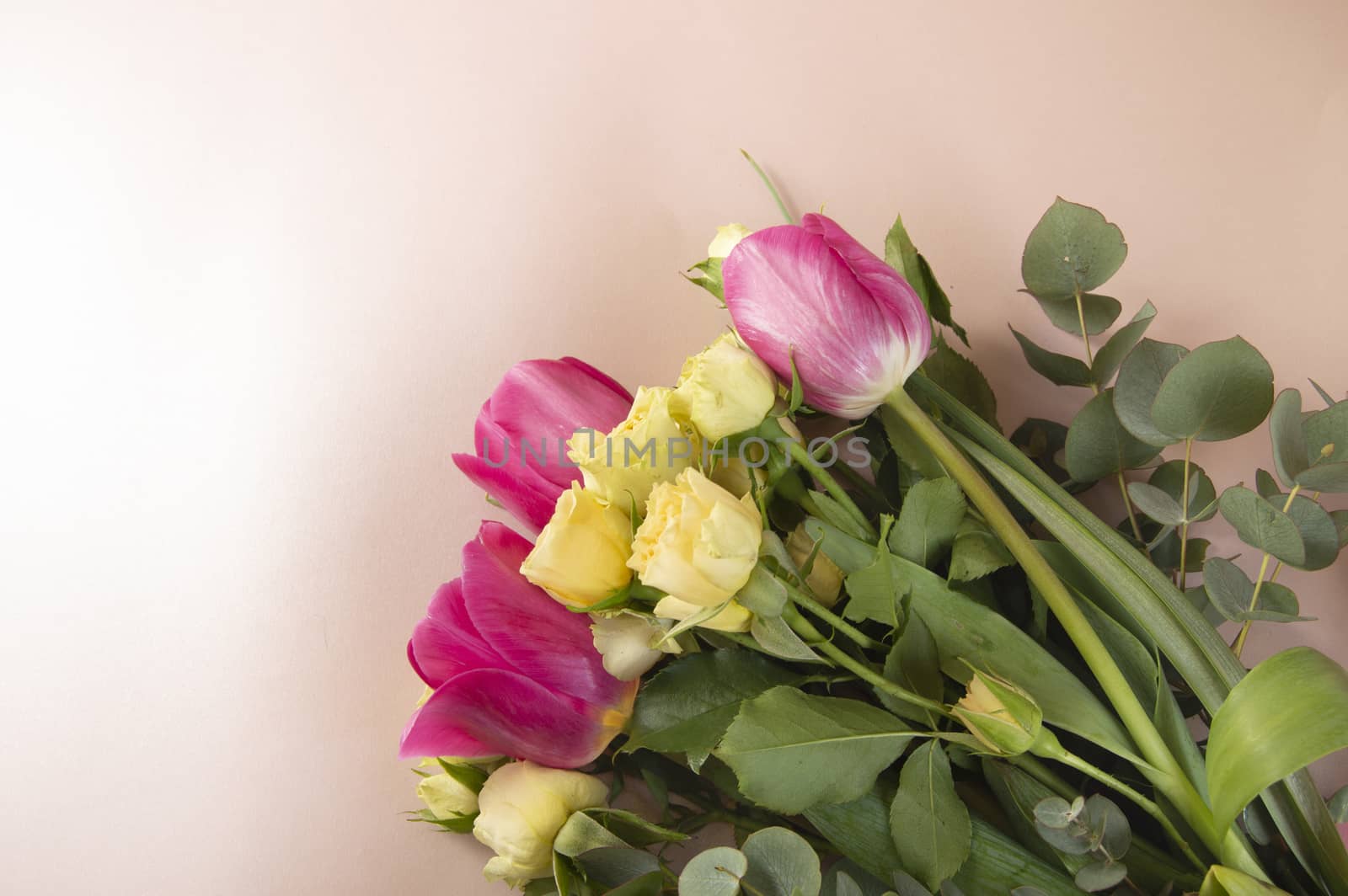 Flat lay flower arrangement with roses and tulips on a pink background top view by claire_lucia