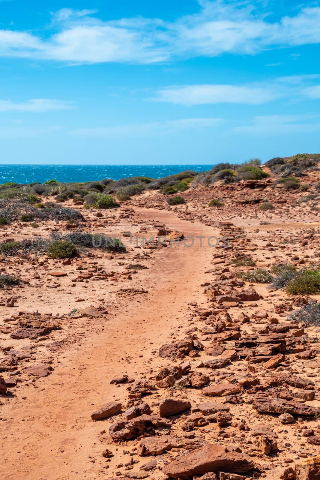 Hiking path over red sand near Mushroom Rock in the Kalbarri Australia by MXW_Stock