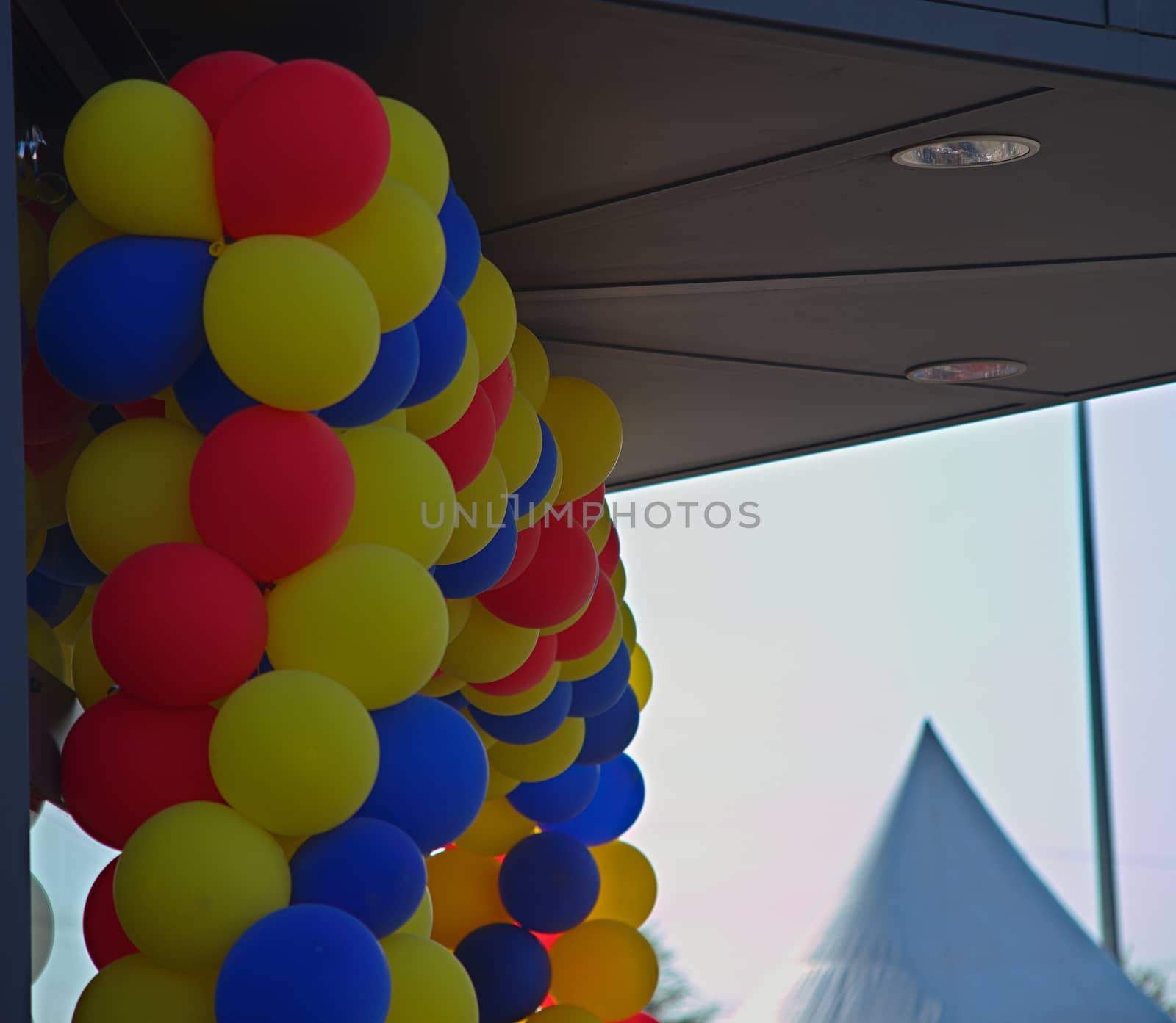 Colorful balloons over glass entrance door by sheriffkule