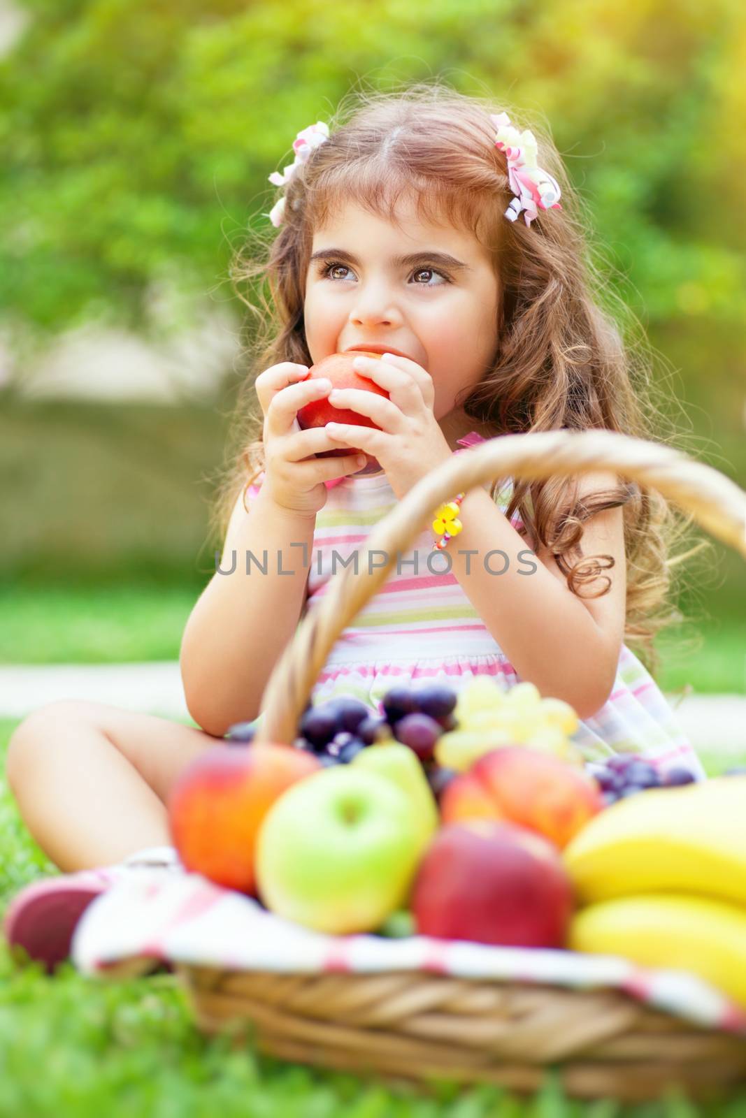 Little girl eating an apple by Anna_Omelchenko