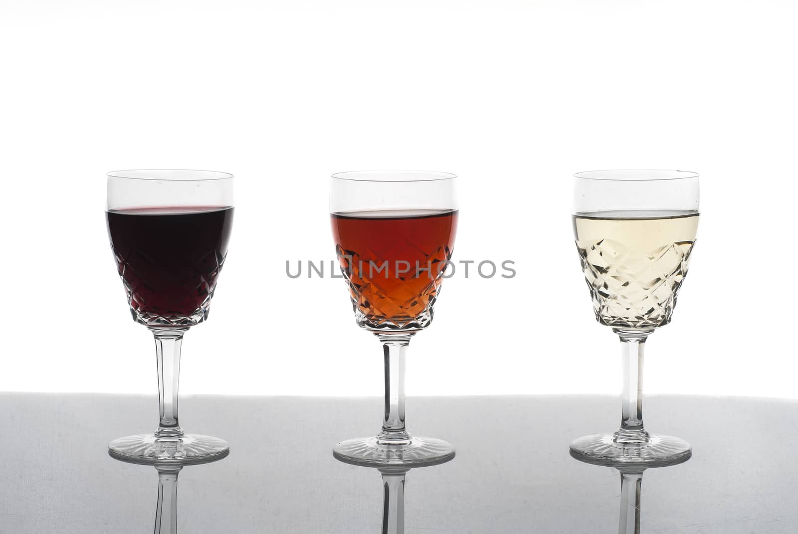 Three glasses of wine, rose wine, red wine, white wine, white background