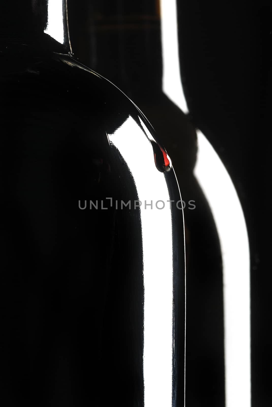 Two bottles of wine, wine drop, black background by jalonsohu@gmail.com