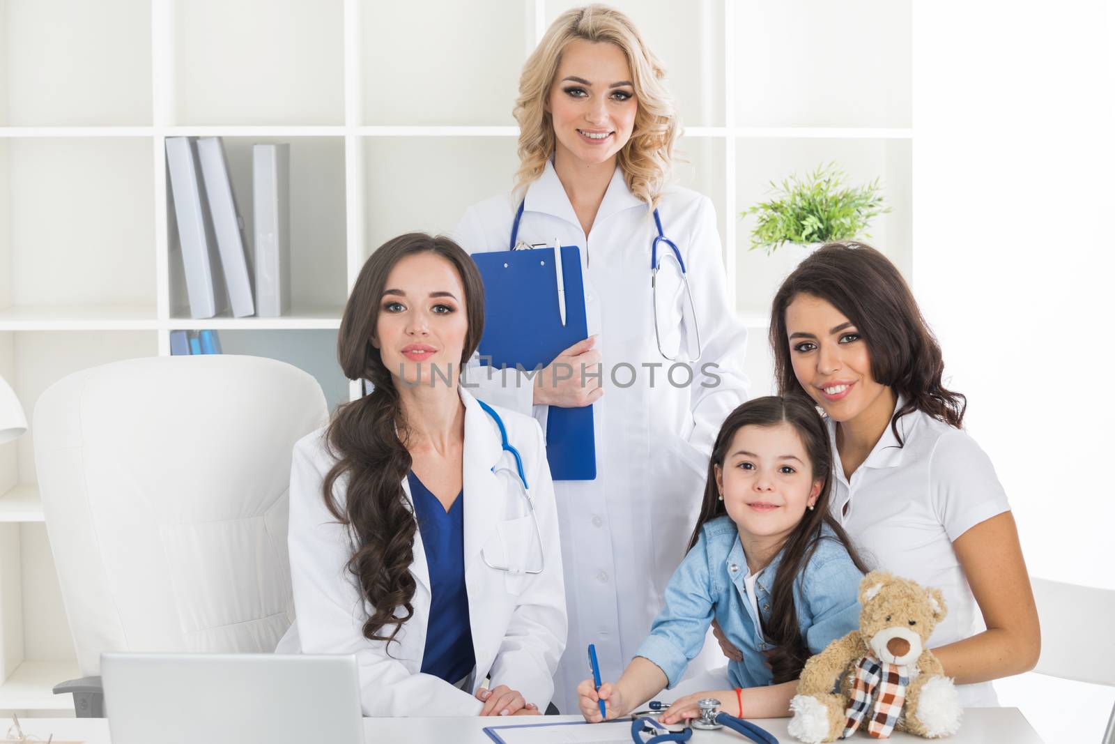 Little girl with her mother at pediatrician on consultation