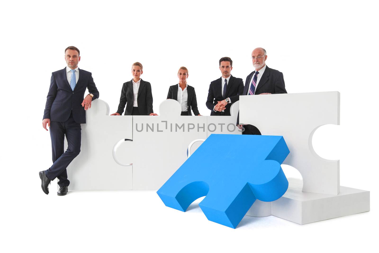 Business teamwork and cooperation concept . Portrait of group of business people with giant puzzle pieces . Partnership and collaborationconcept, studio isolated on white background