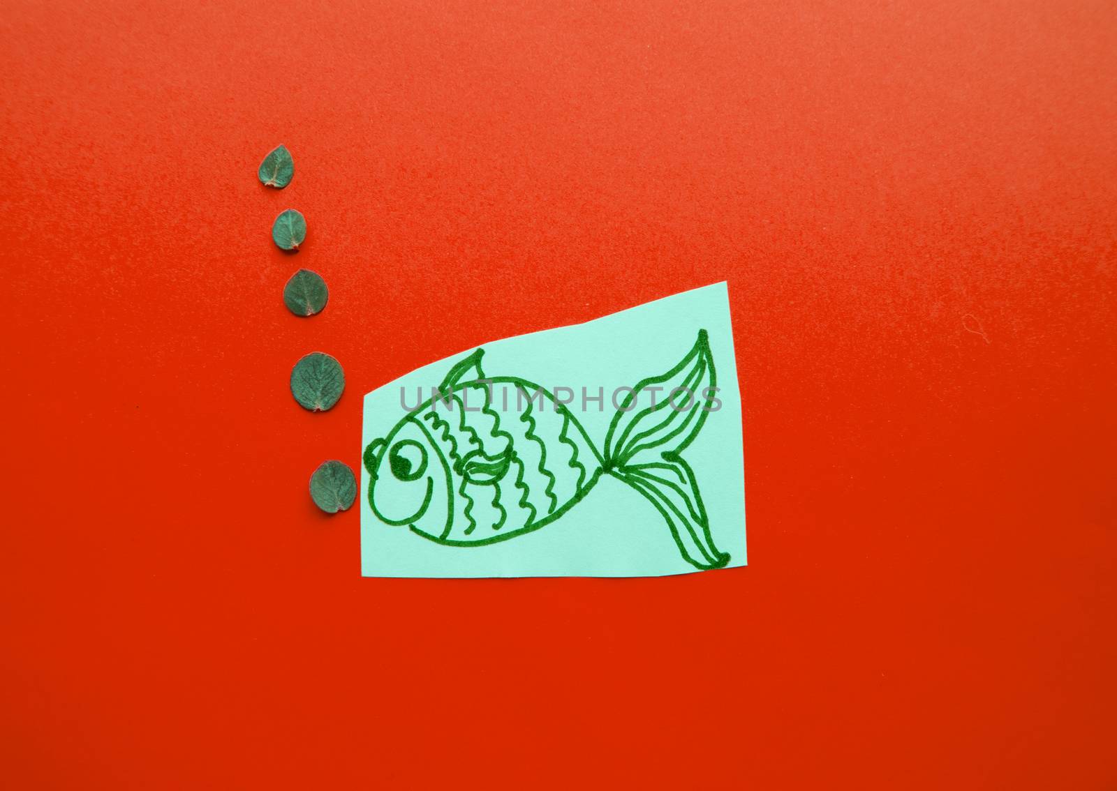 Funny fish with bubbles on red background, fool's Day.