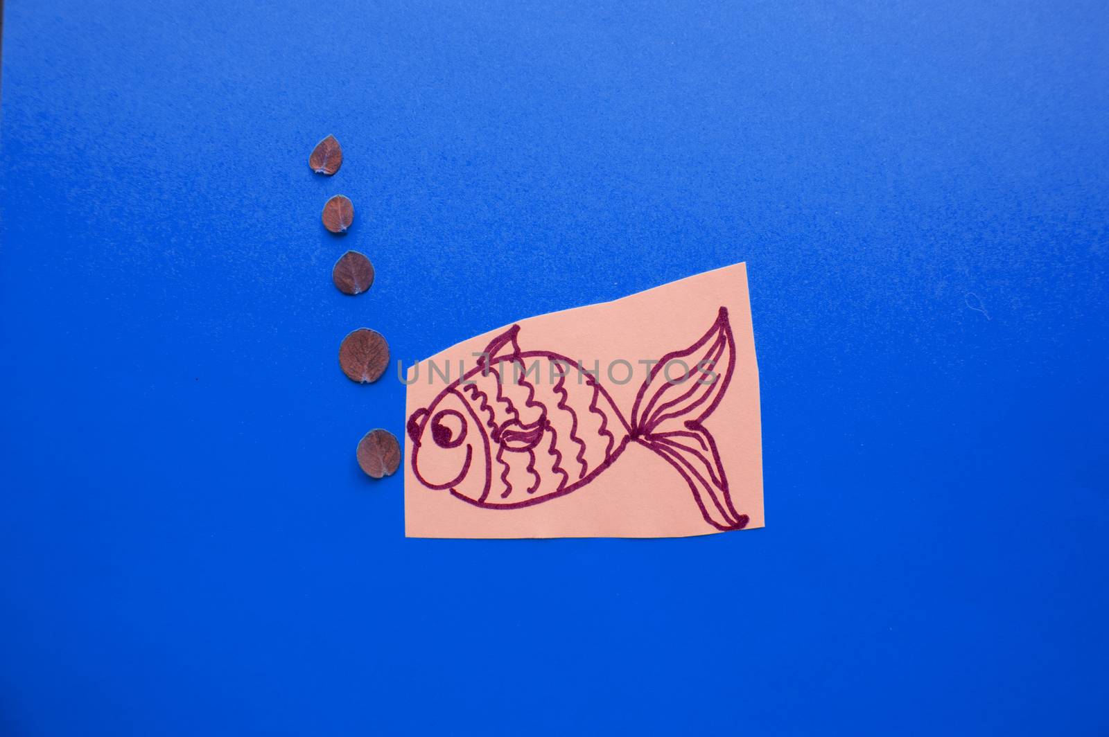 Funny fish with bubbles on blue background, fool's Day.