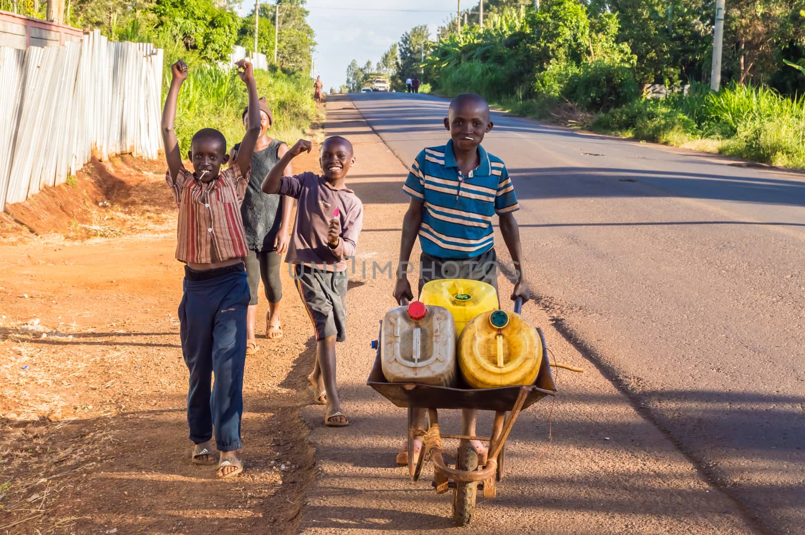 Four young Kenyans carrying water by Philou1000