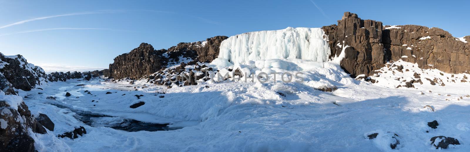 Frozen waterfall Oexararfoss within the Thingvellir National Park, Iceland, Europe