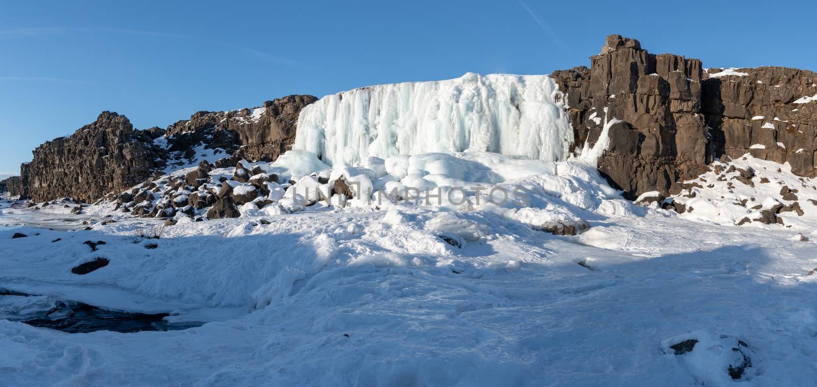 Frozen waterfall Oexararfoss within the Thingvellir National Park, Iceland, Europe