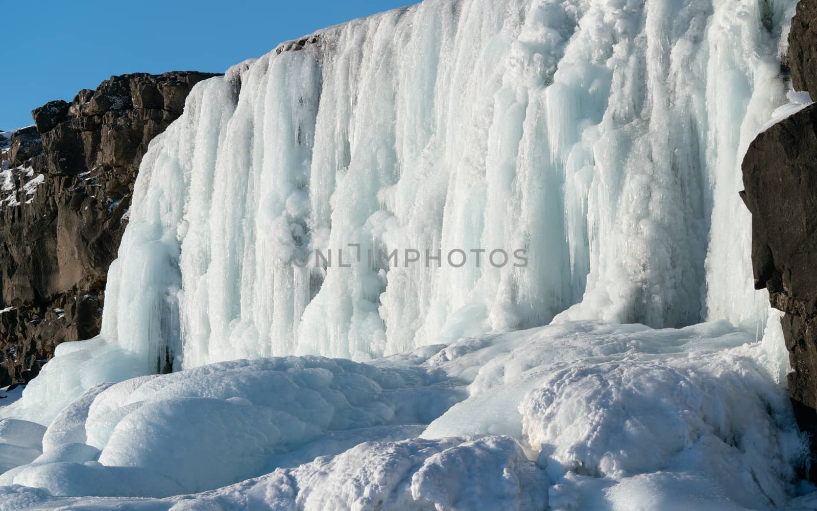 Frozen waterfall Oexararfoss within the Thingvellir National Park, Iceland, Europe