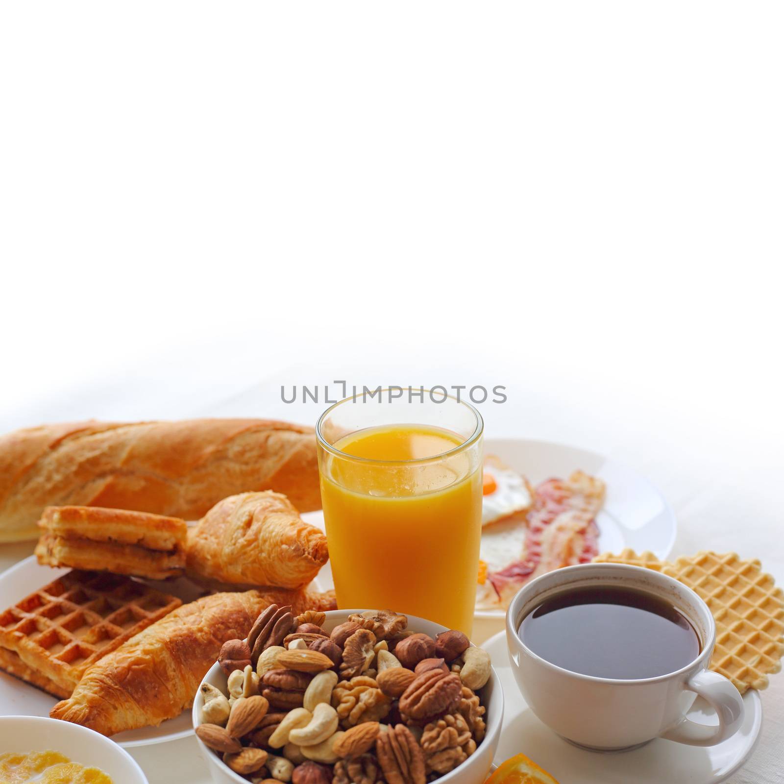 Healthy breakfast with juice ,nuts, coffee, eggs, bread, oat grains and other on white background. White copy space for text, frame