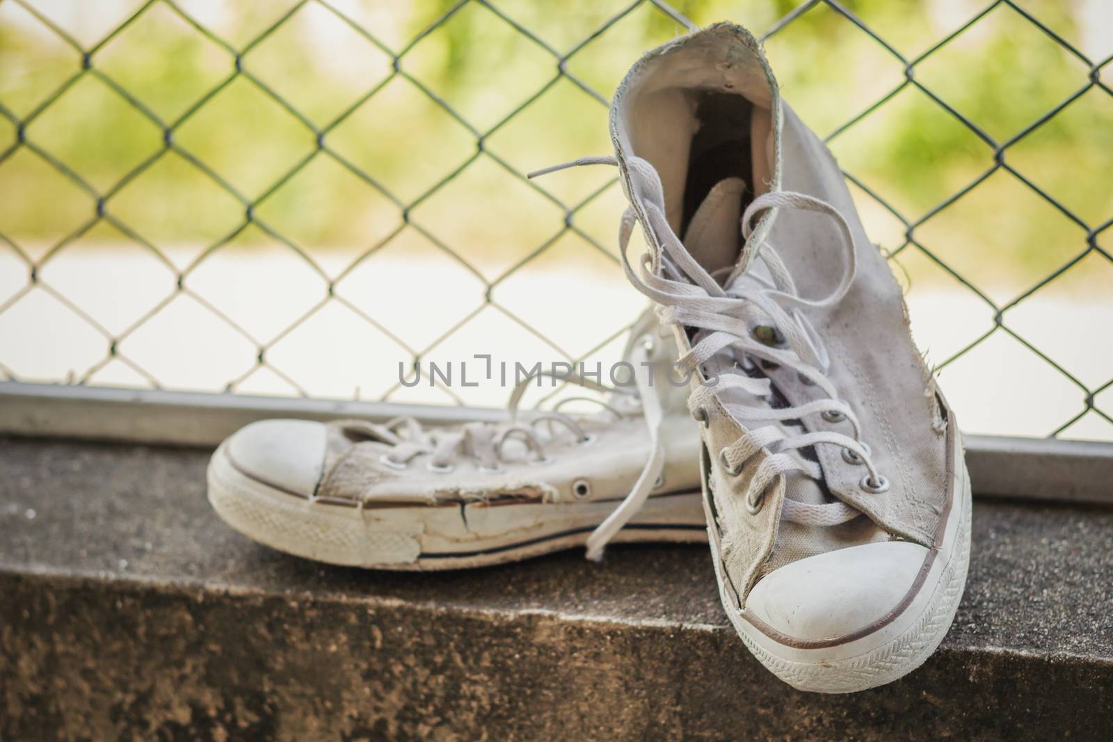 Dirty shoes put on cement floor. The back is a mate mesh.