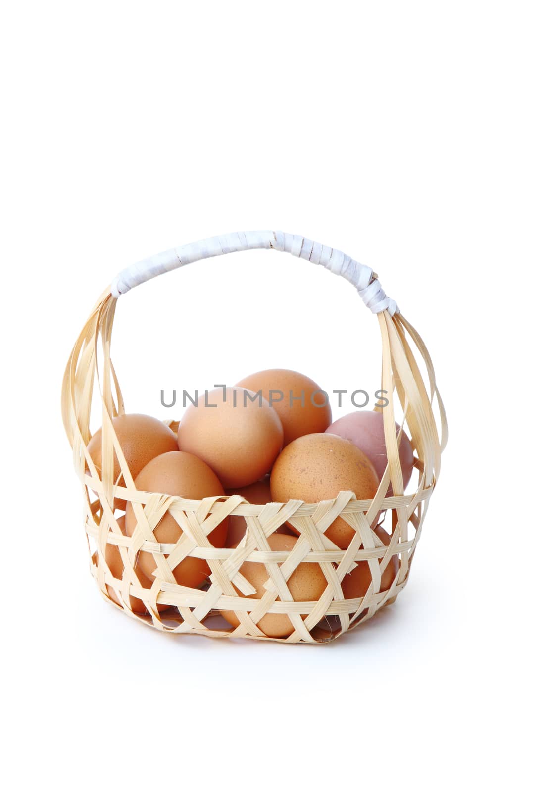 farm fresh chicken eggs in round bamboo basket isolated over white background, clipping path. 