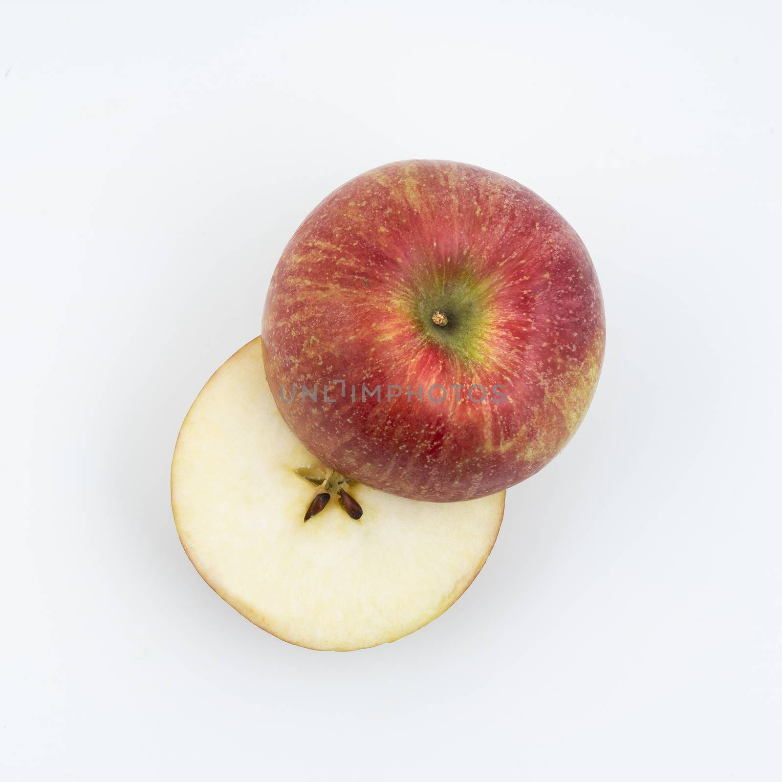 an apple cut on a white surface