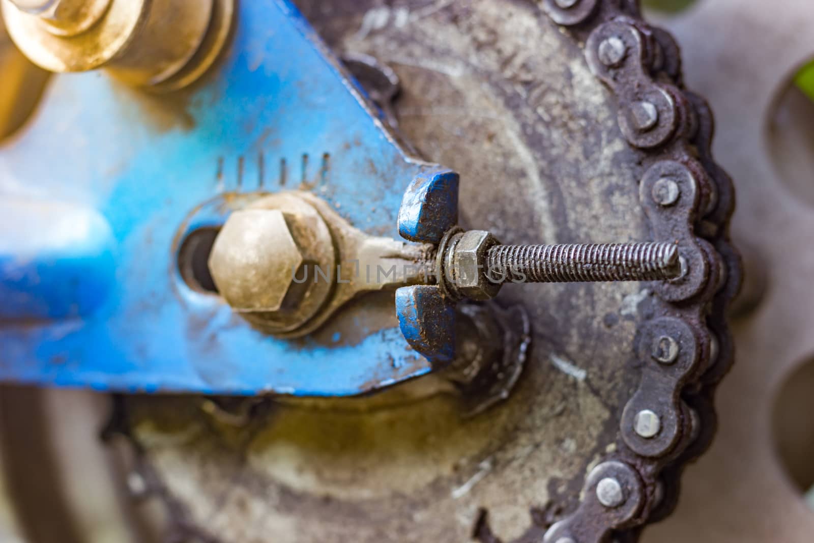 Dirty rear chain around sprocket of classic motorcycle wheel. by SaitanSainam