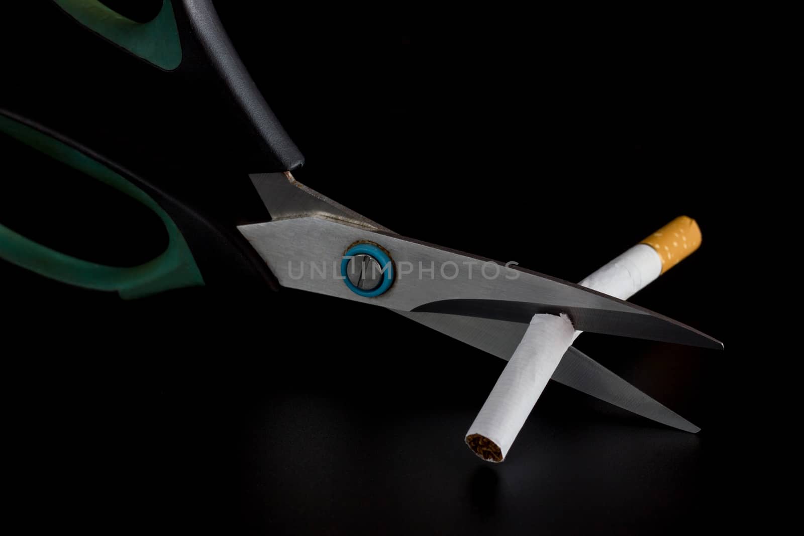 Anti Tobacco, Cigarette were scissors cut off on dark background by SaitanSainam