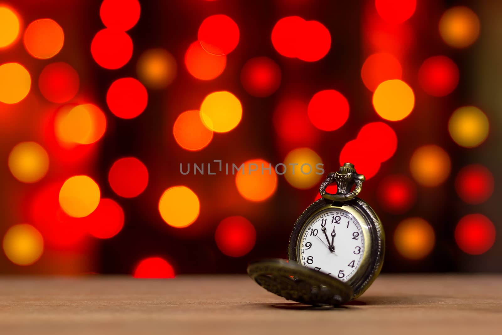 Closeup vintage old clock in the bokeh on brown wood background. by SaitanSainam