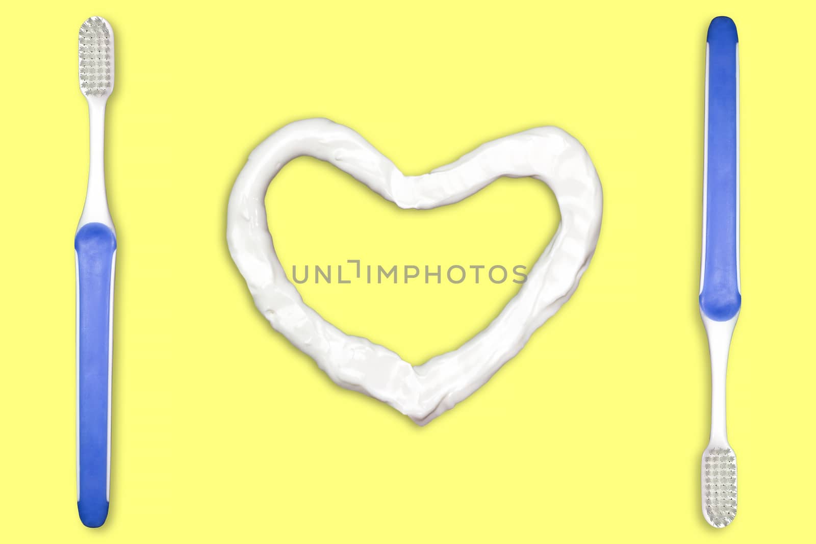 Toothbrush and heart shaped toothpaste. Concept for Healthy Dental Campaign. We love to brush our teeth. Isolate on yellow background.