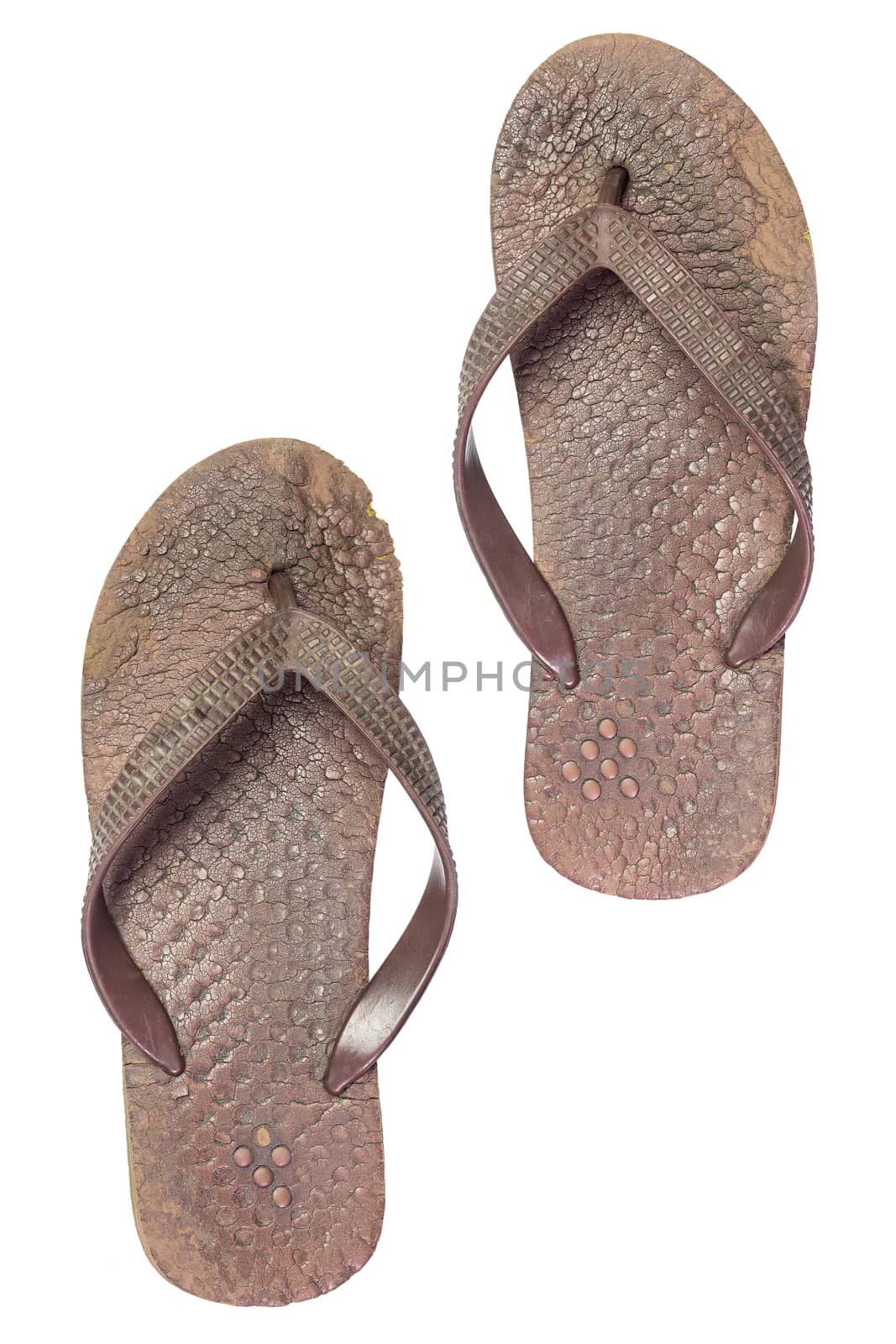 Old brown sandals on isolate white background. Very dirty slippers.