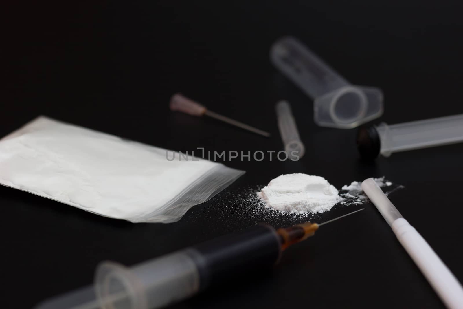 Fake Heroin or diacetylmorphine bag and syringes placed side by  by SaitanSainam