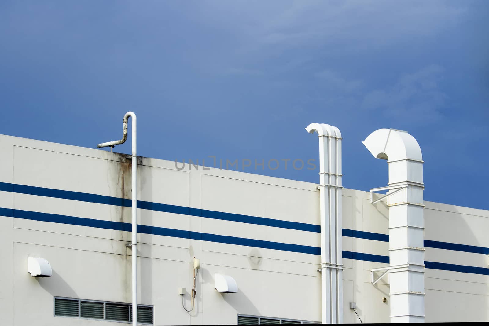 Steel air ducts white outside the building with blue sky by TakerWalker