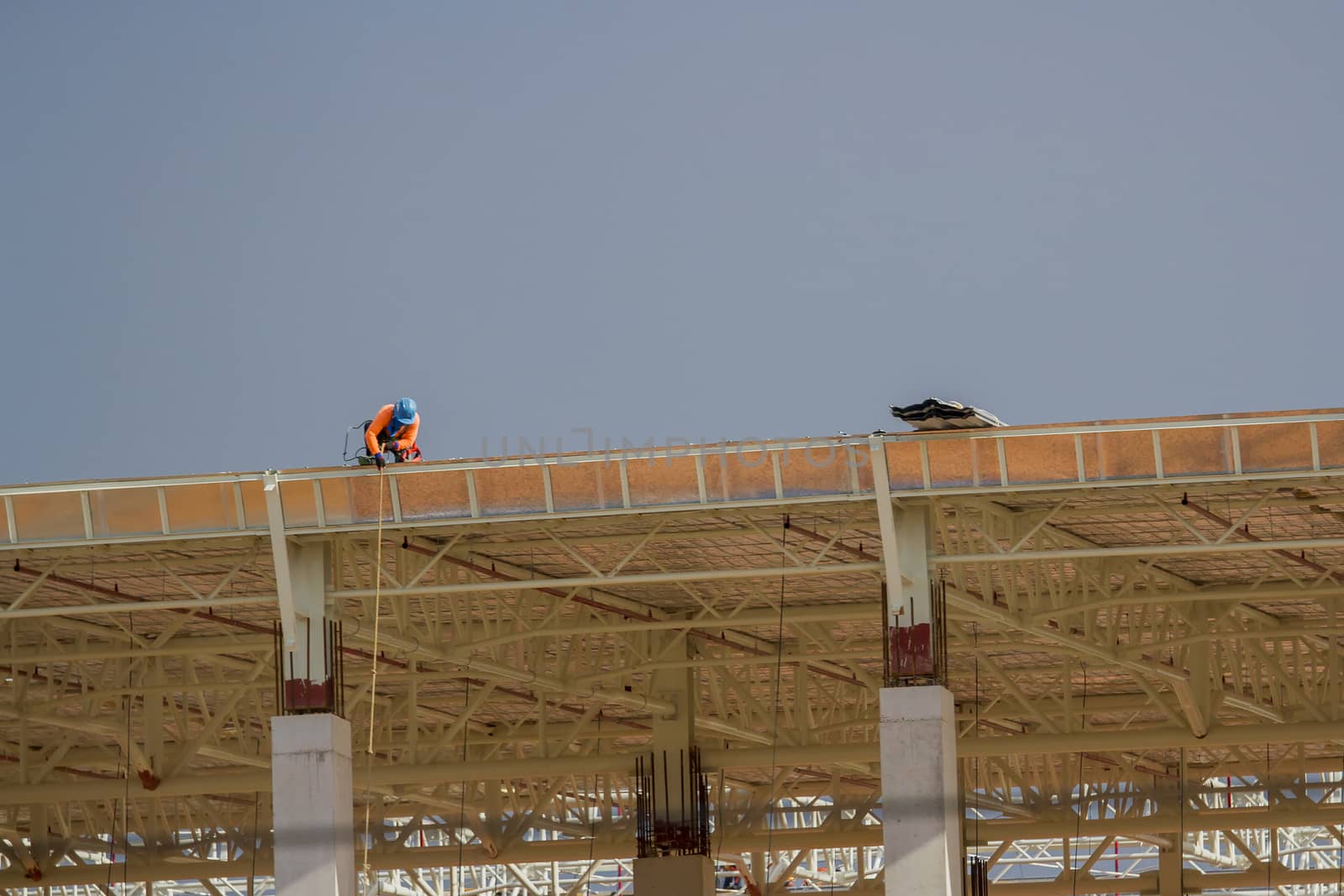 Construction workers on the roof of the building.