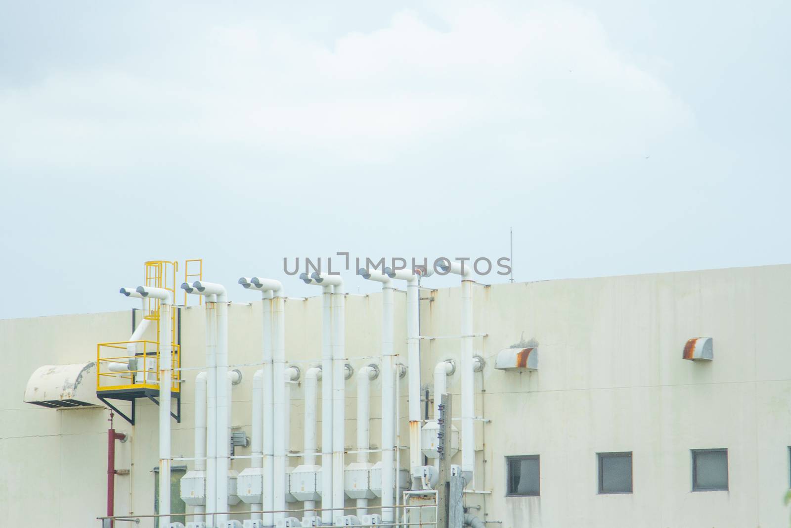 Several white ventilation vents are located next to the building.