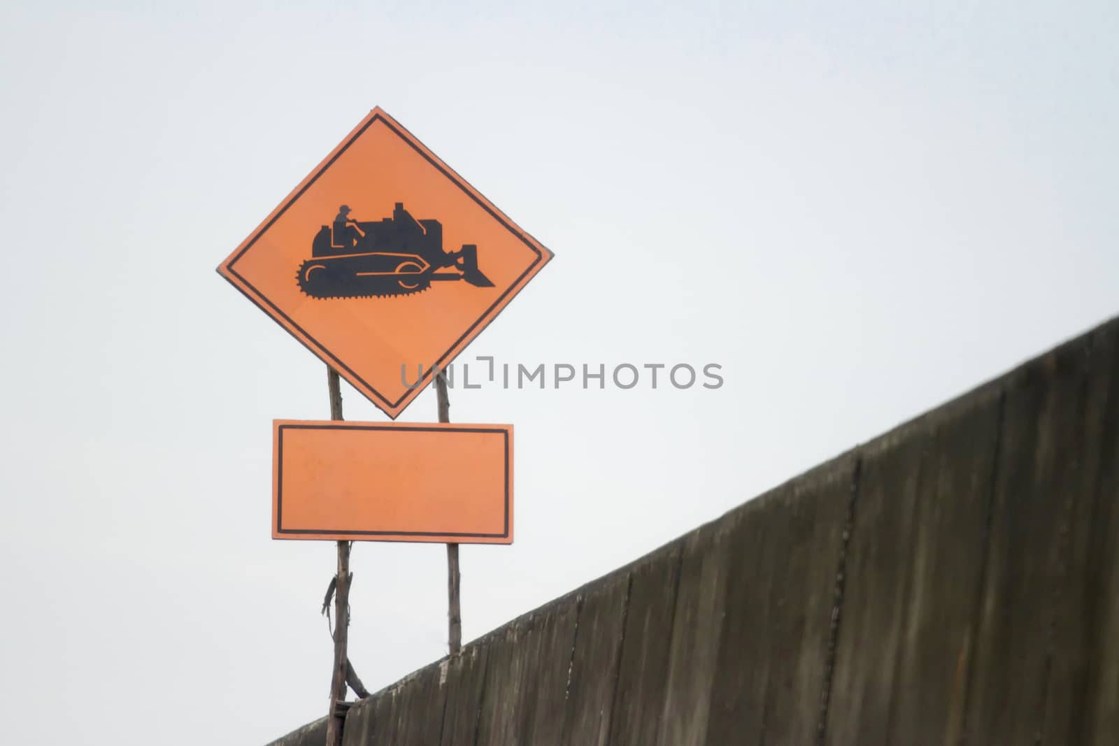 Sign for working tractor black symbol orange background