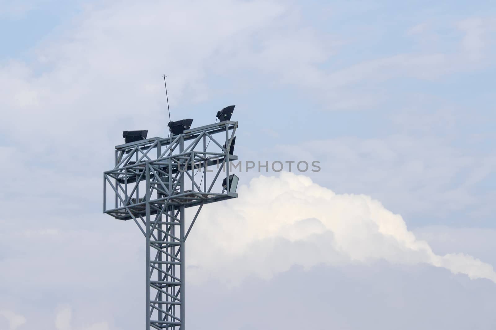 Spotlight tower for sport on blue sky