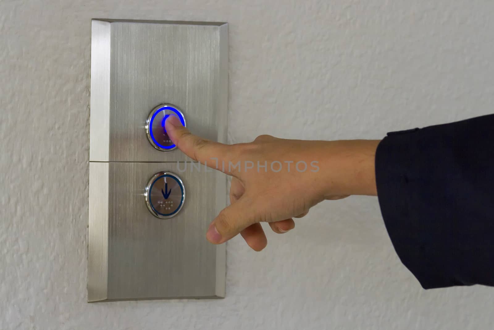 Using hands, press the elevator up and keypad elevator