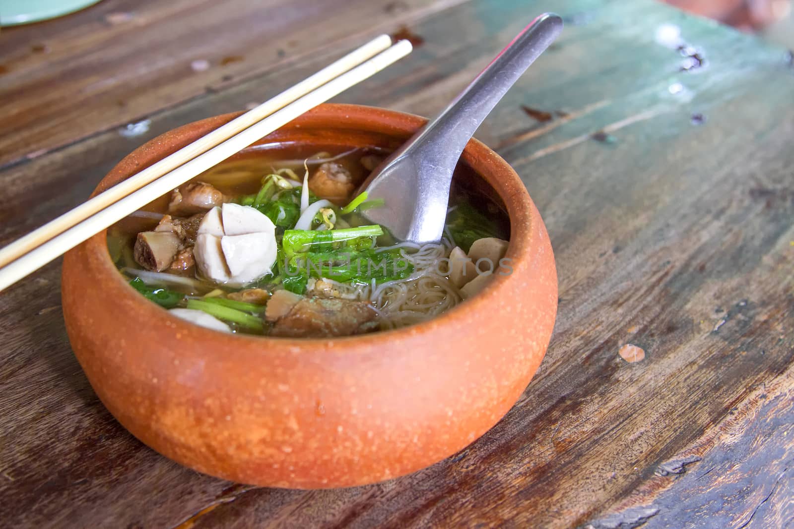 Clay pot rice noodles put on a wooden table by TakerWalker