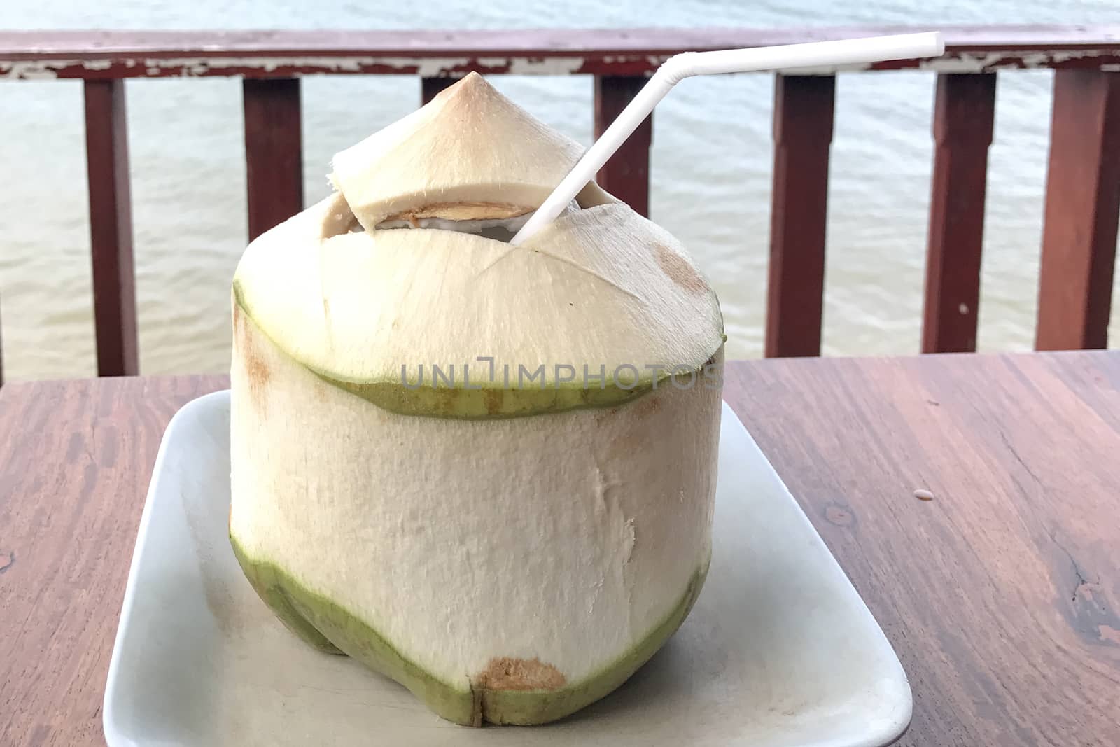 Coconut put on a brown table ready to drink