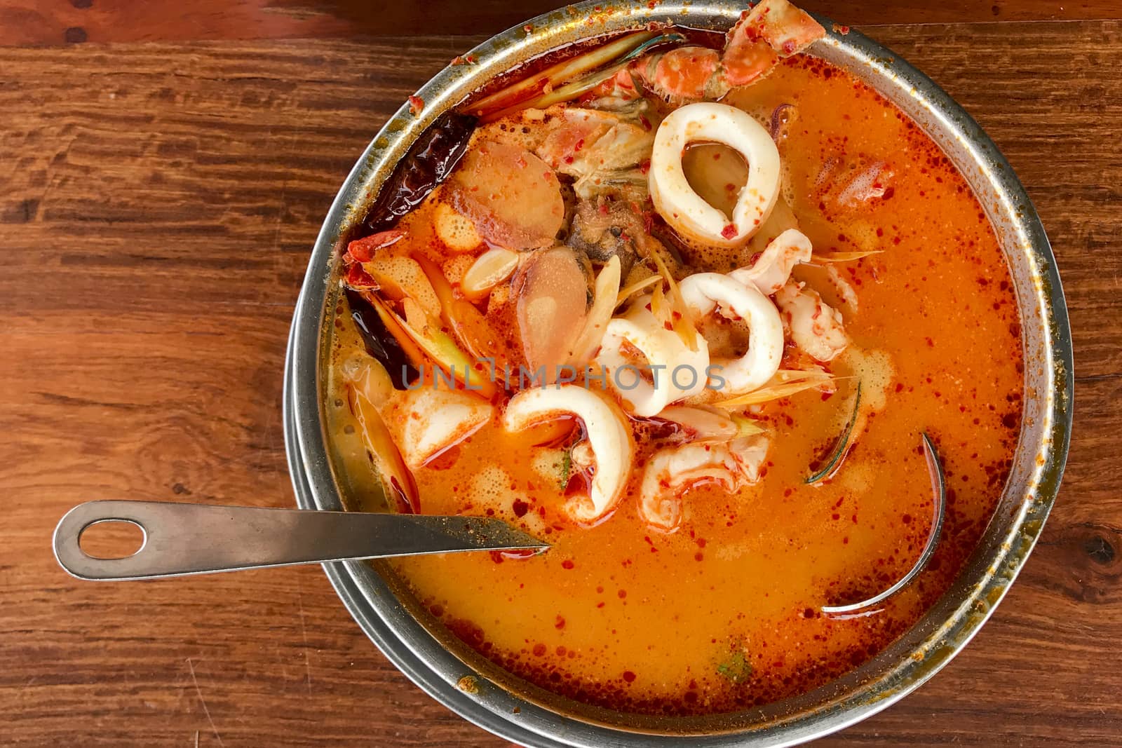 Tom Yum Goong put on a wooden table top view 