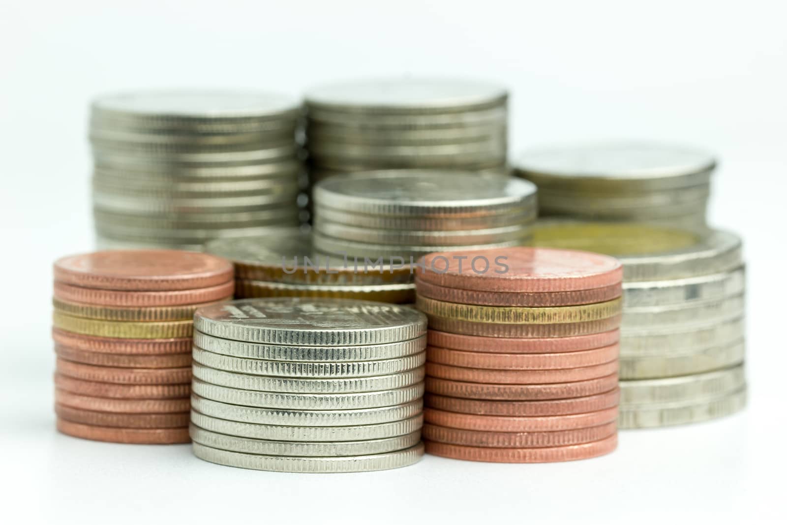 Closeup the coins are stacked neatly on a white background. Suitable for use in business or financial articles.