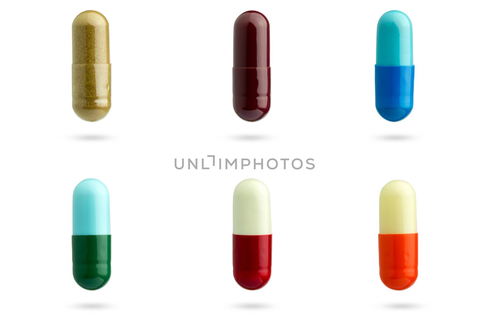 Closeup set of multicolor capsule medication on white background by SaitanSainam