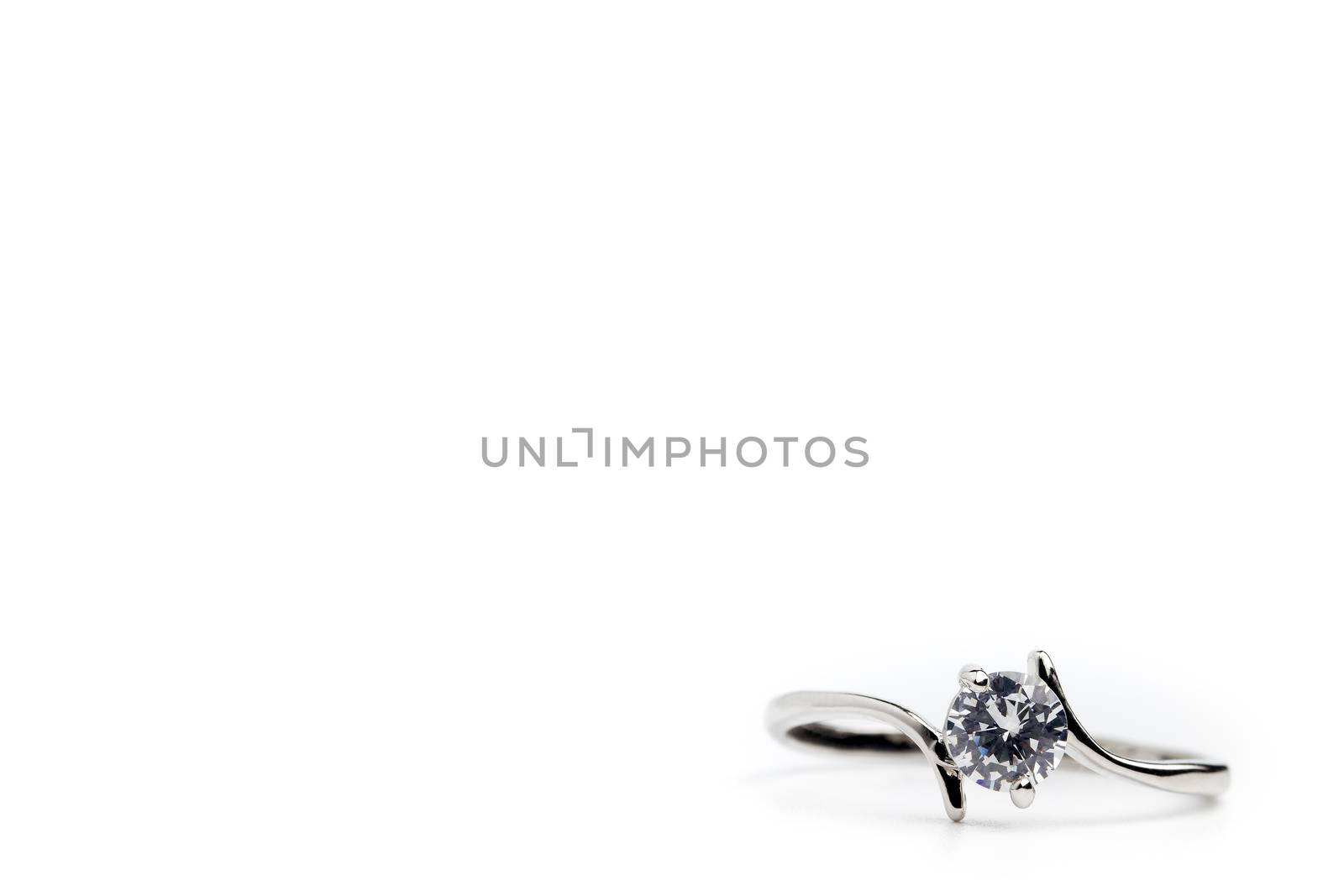 Fake diamond ring placed on a white background. The concept of l by SaitanSainam