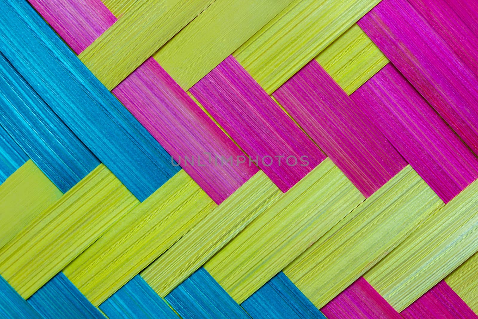 Closeup the bamboo was cut into thin sheets, dyed colorful and was woven into a piece.