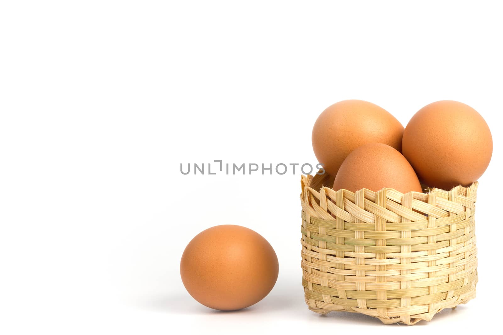 Egg in the bamboo basket on white background.