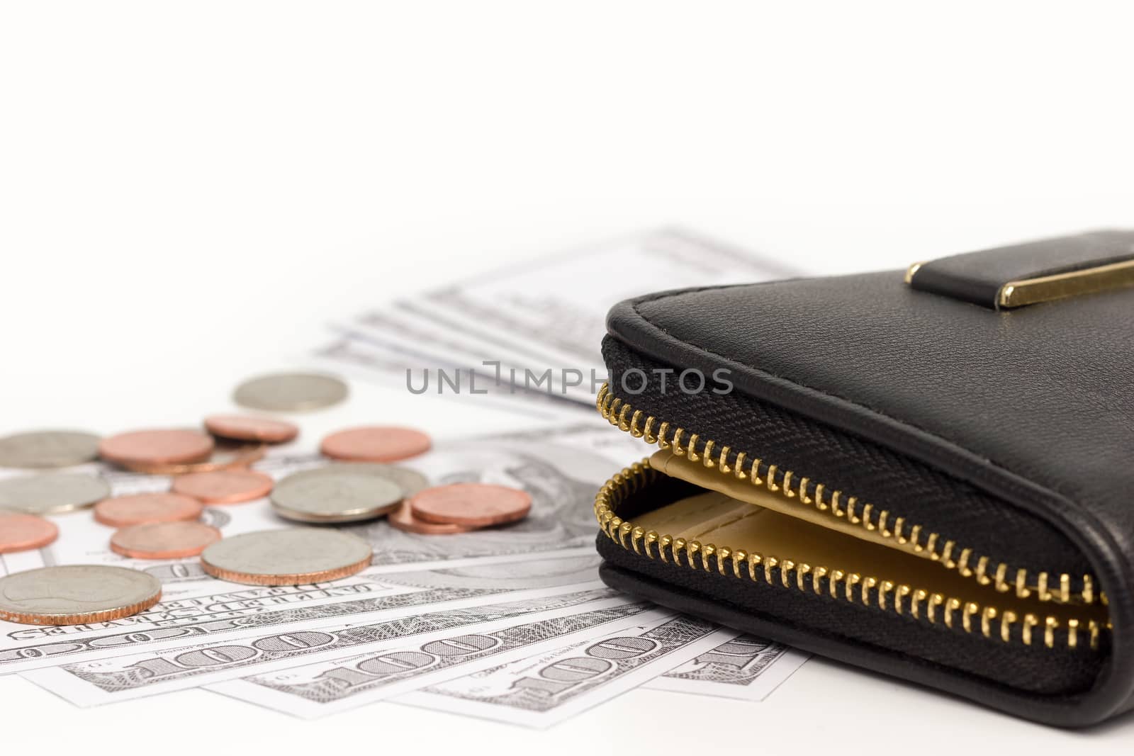 Black leather wallet with banknote and coins on white background.