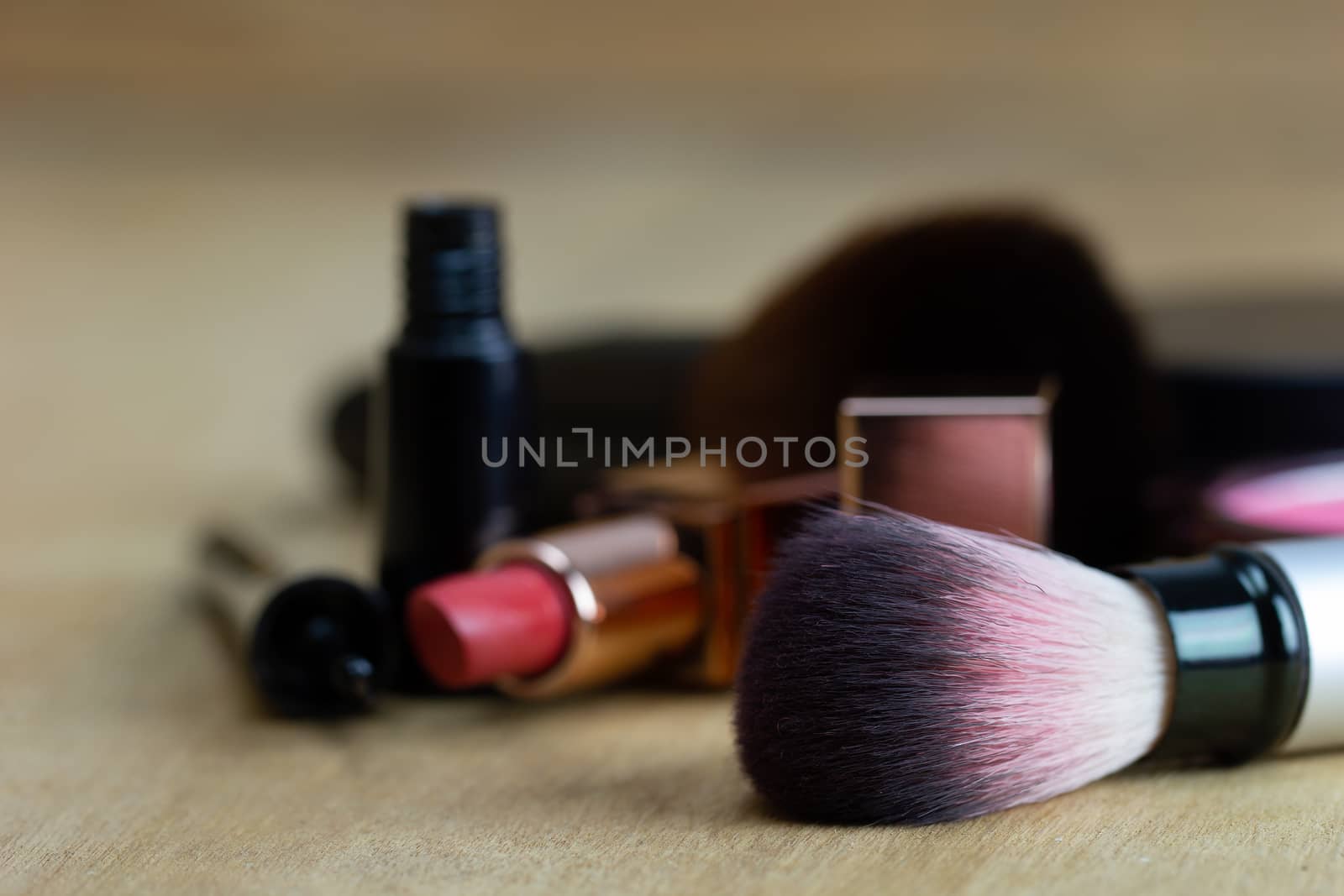 Cosmetics put on a brown wood table. Suitable for backgrounds, a by SaitanSainam