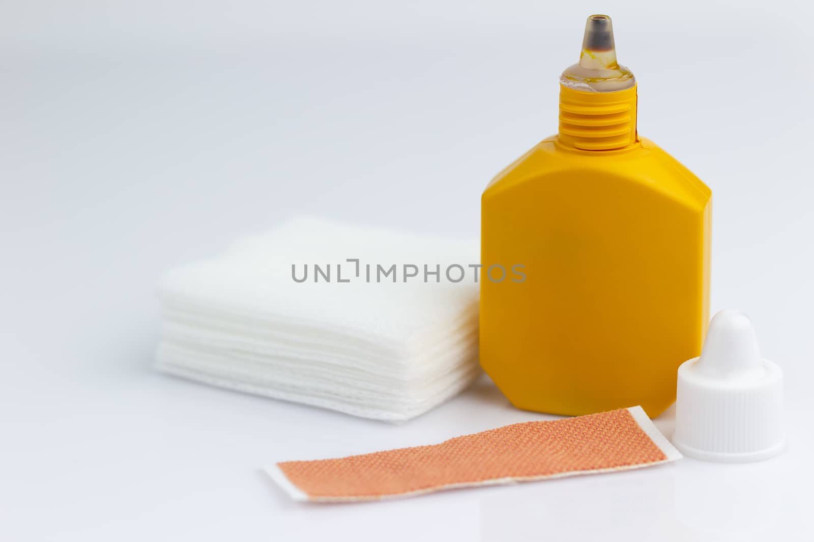 Mercurochrome, alcohol, gauze and adhesive plaster on white background.The concept of First Aid Equipment.