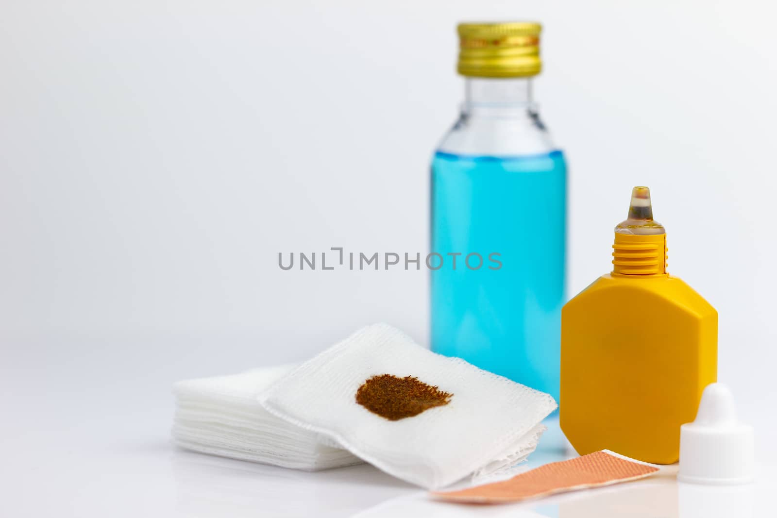 Mercurochrome, alcohol, gauze and adhesive plaster on white background.The concept of First Aid Equipment.