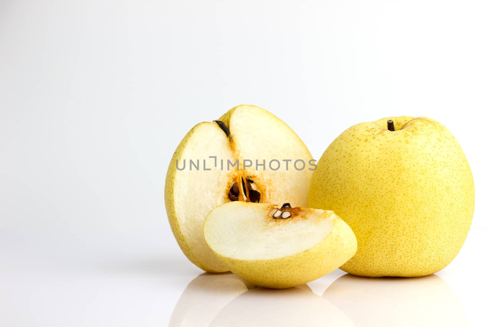 Chinese pear and reflection on white background. Healthy fruit.
