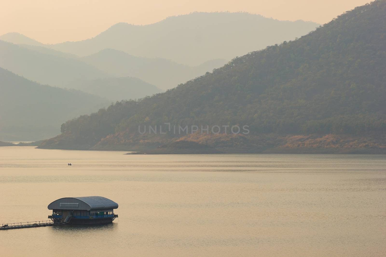 Raft floating on the middle of a dam or lake in the evening.